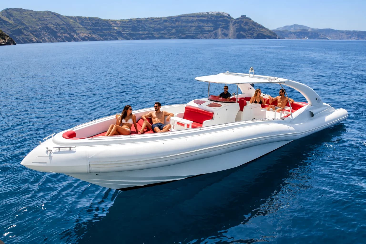 Opera 60 maxi RIB: white speedboat with red seating and guests on the Atlantic